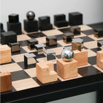 Wooden and metallic chess pieces on a chessboard