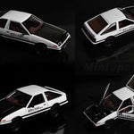 Model car with open and closed doors on a dark background