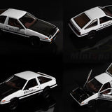 Model car with open and closed doors on a dark background