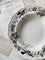 Decorative plate with floral and bird patterns on a surface with handwritten text.