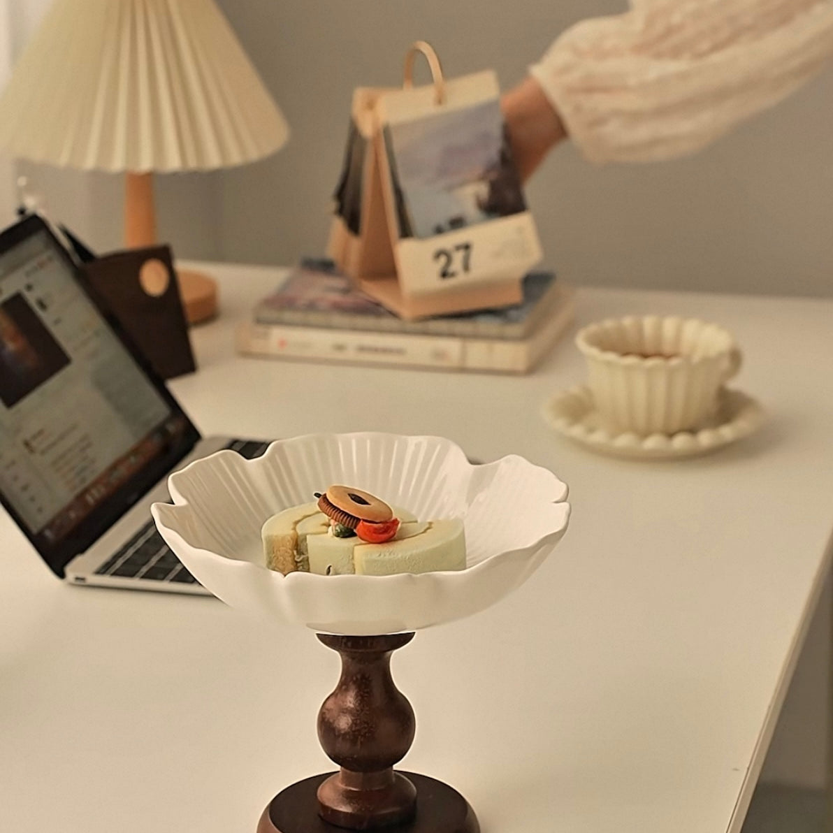 Decorative bowl with snacks on a desk next to a laptop